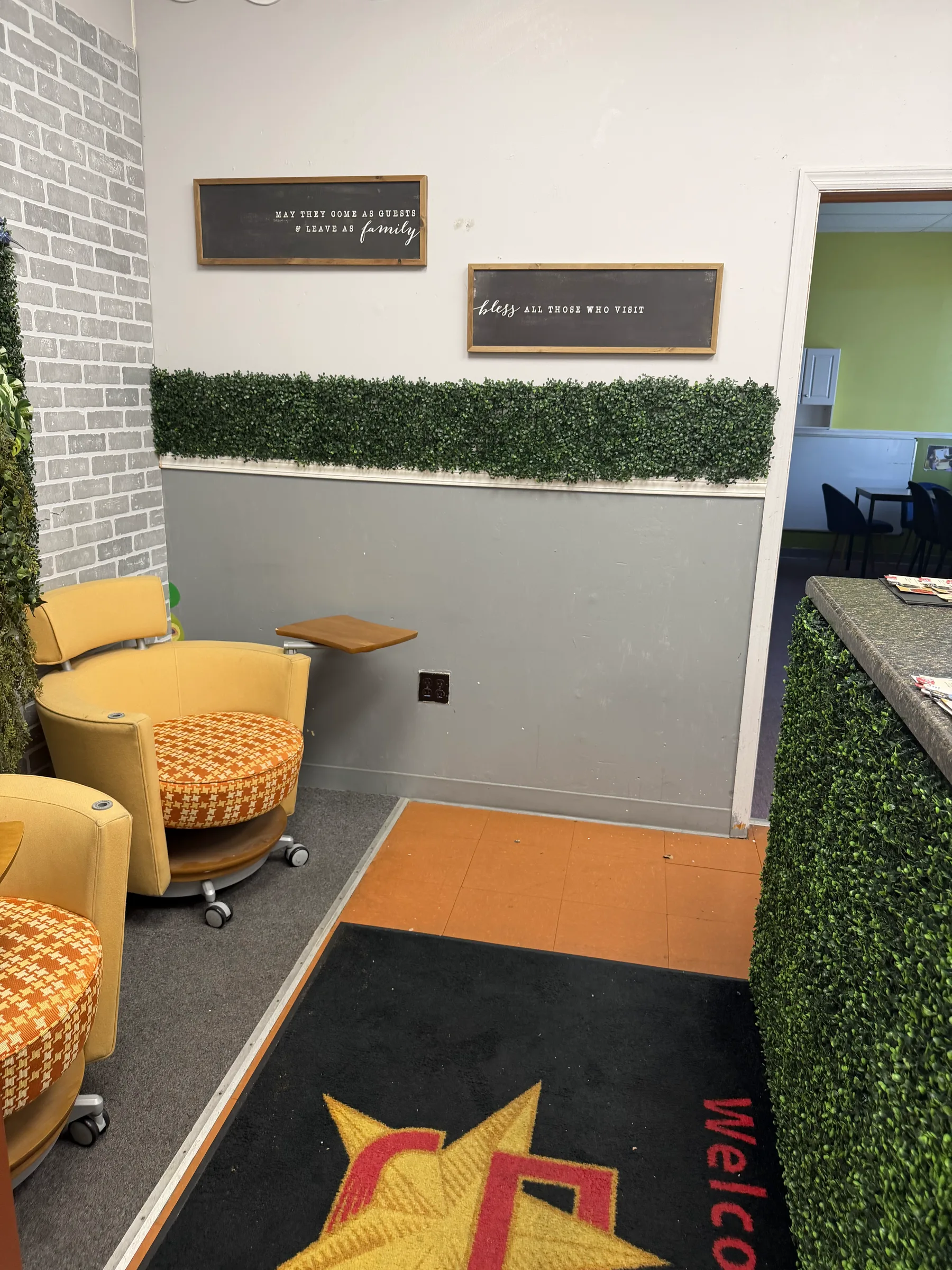 Interior hallway with 5 Star Impact branded rugs and wall signage.